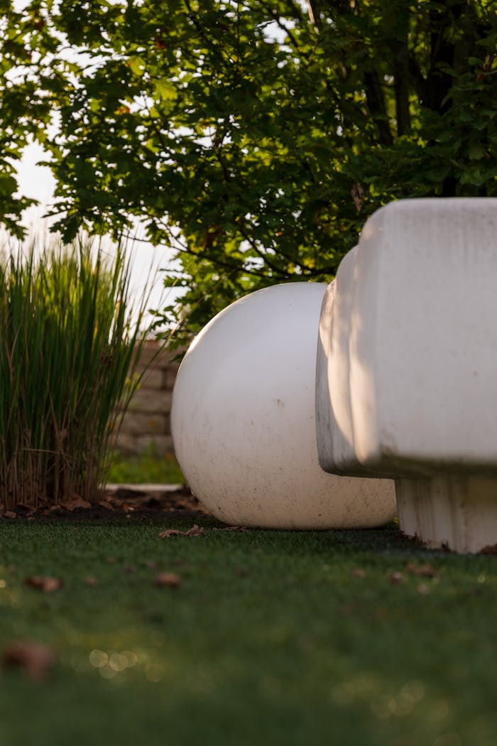 Offerings Serene garden scene with abstract stone sculptures and lush greenery.